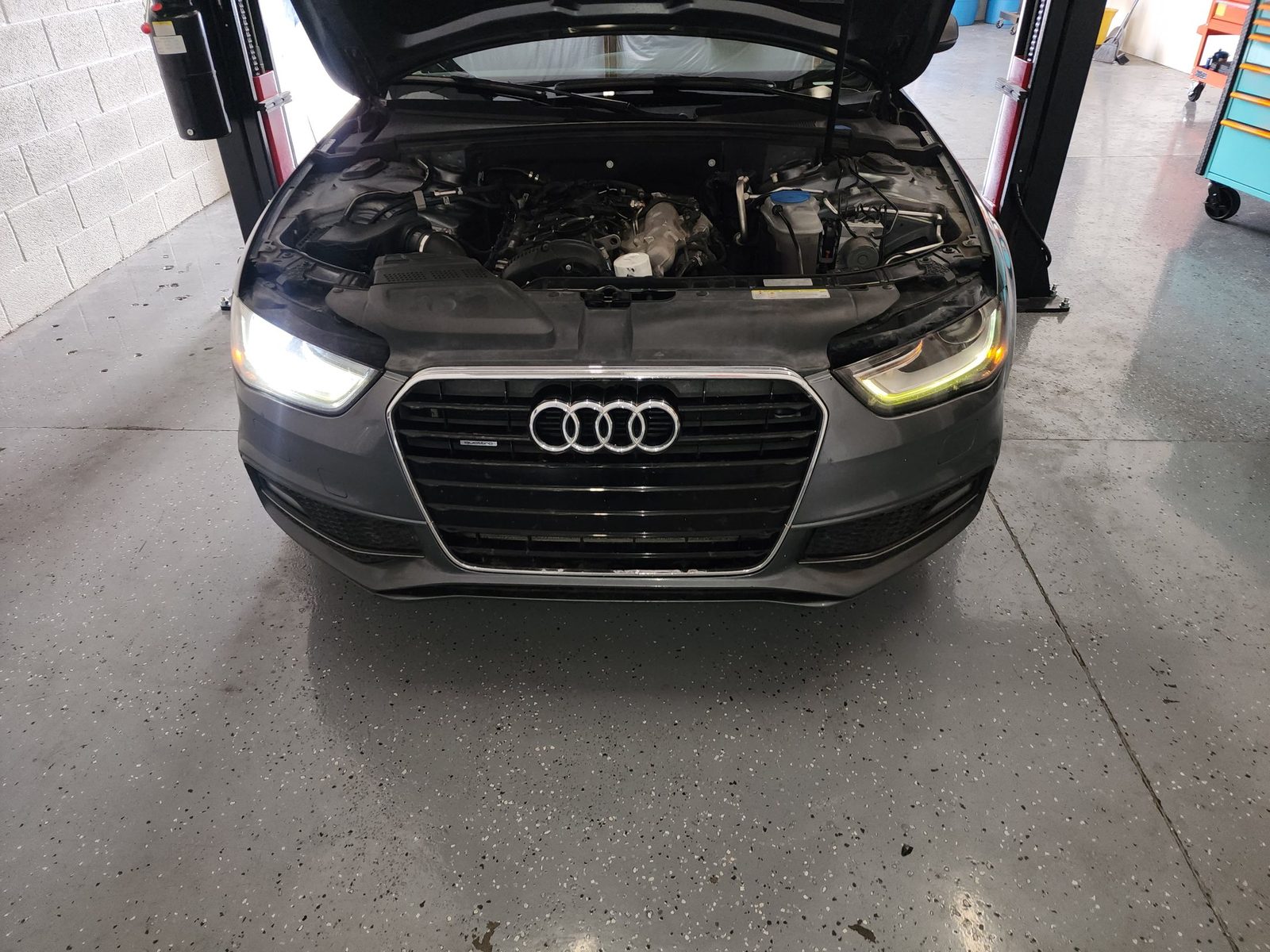 Audi in the service bay with the hood open for diagnostics